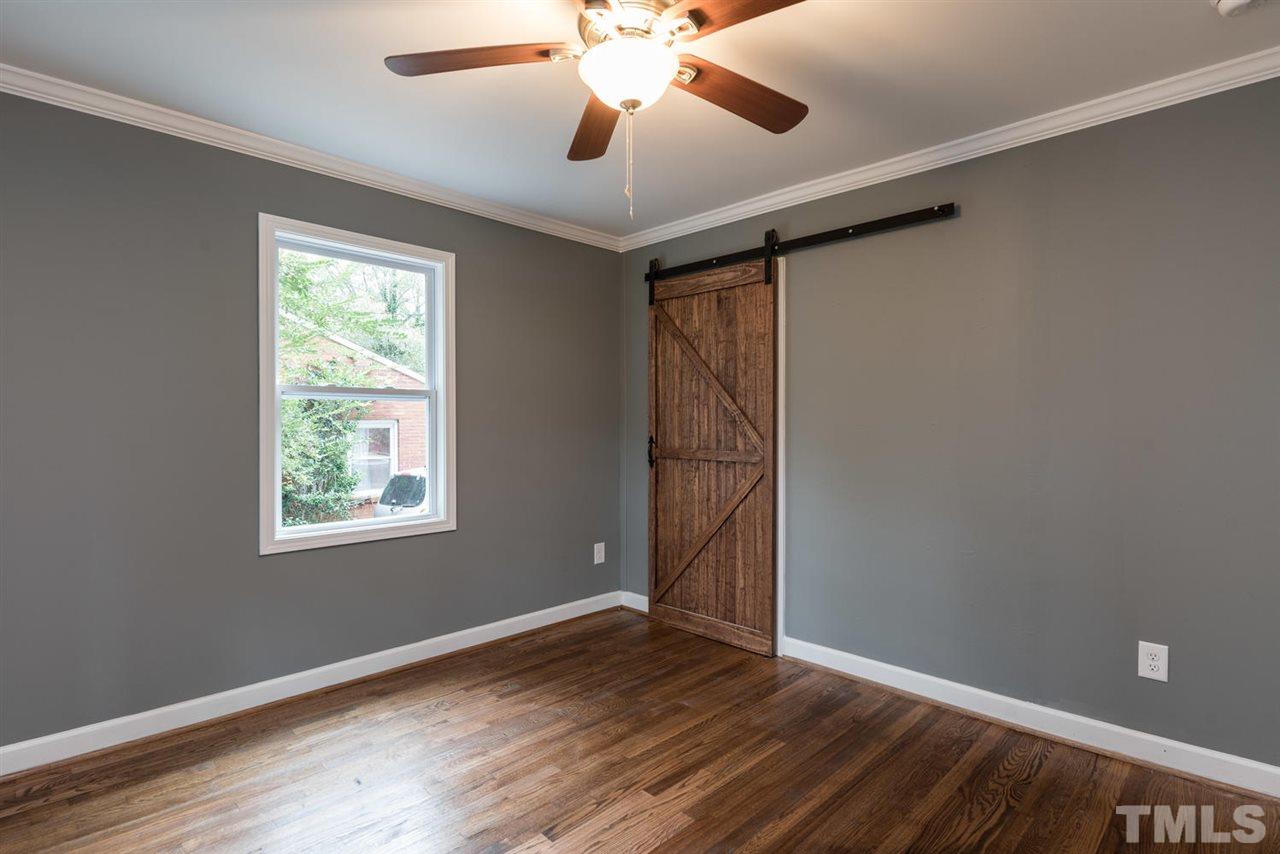 2408 Milburnie Road Raleigh, NC 27610 - Photo 21 of 25 a view of an empty room with window and wooden floor