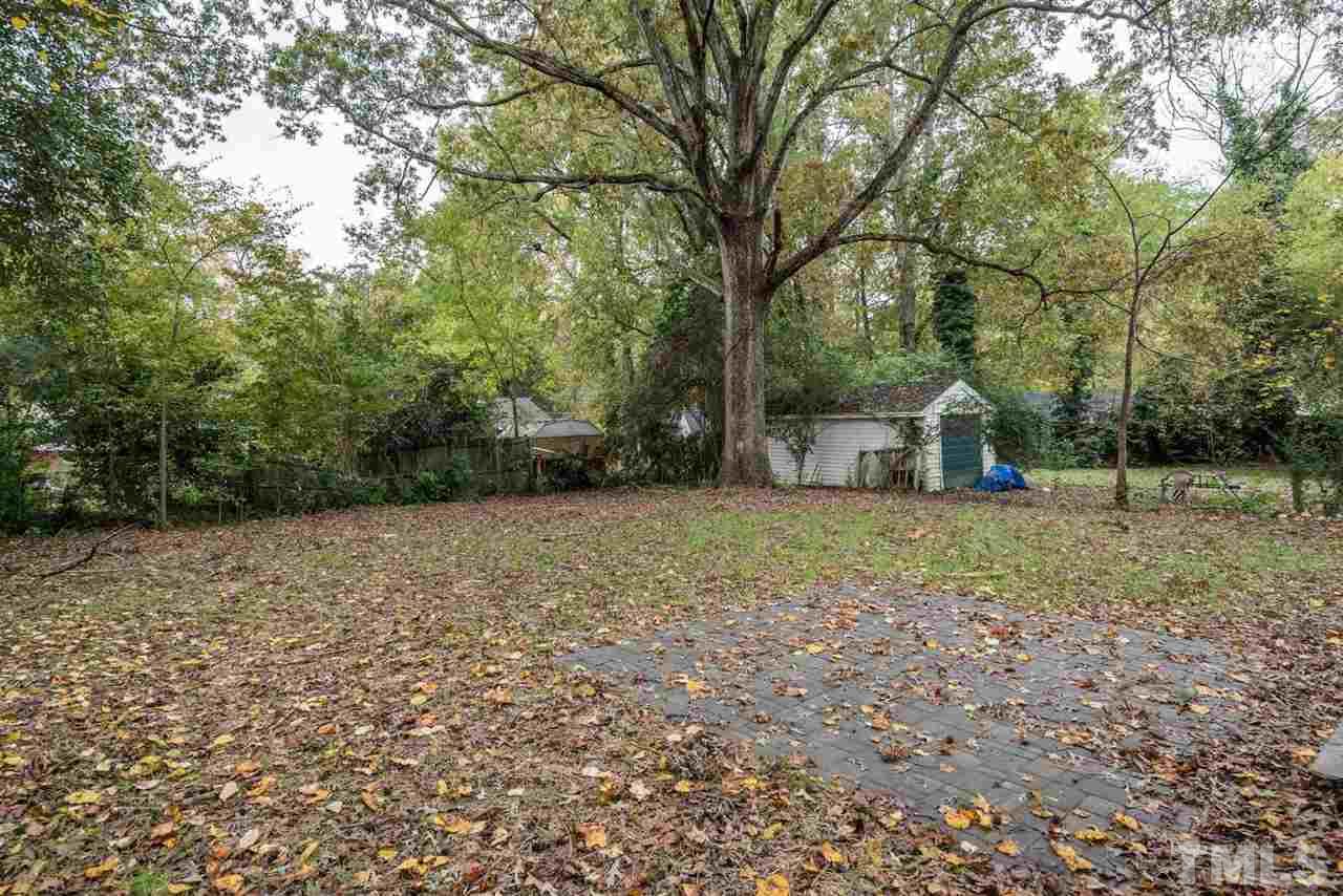 2408 Milburnie Road Raleigh, NC 27610 - Photo 23 of 25 a backyard of a house with lots of green space