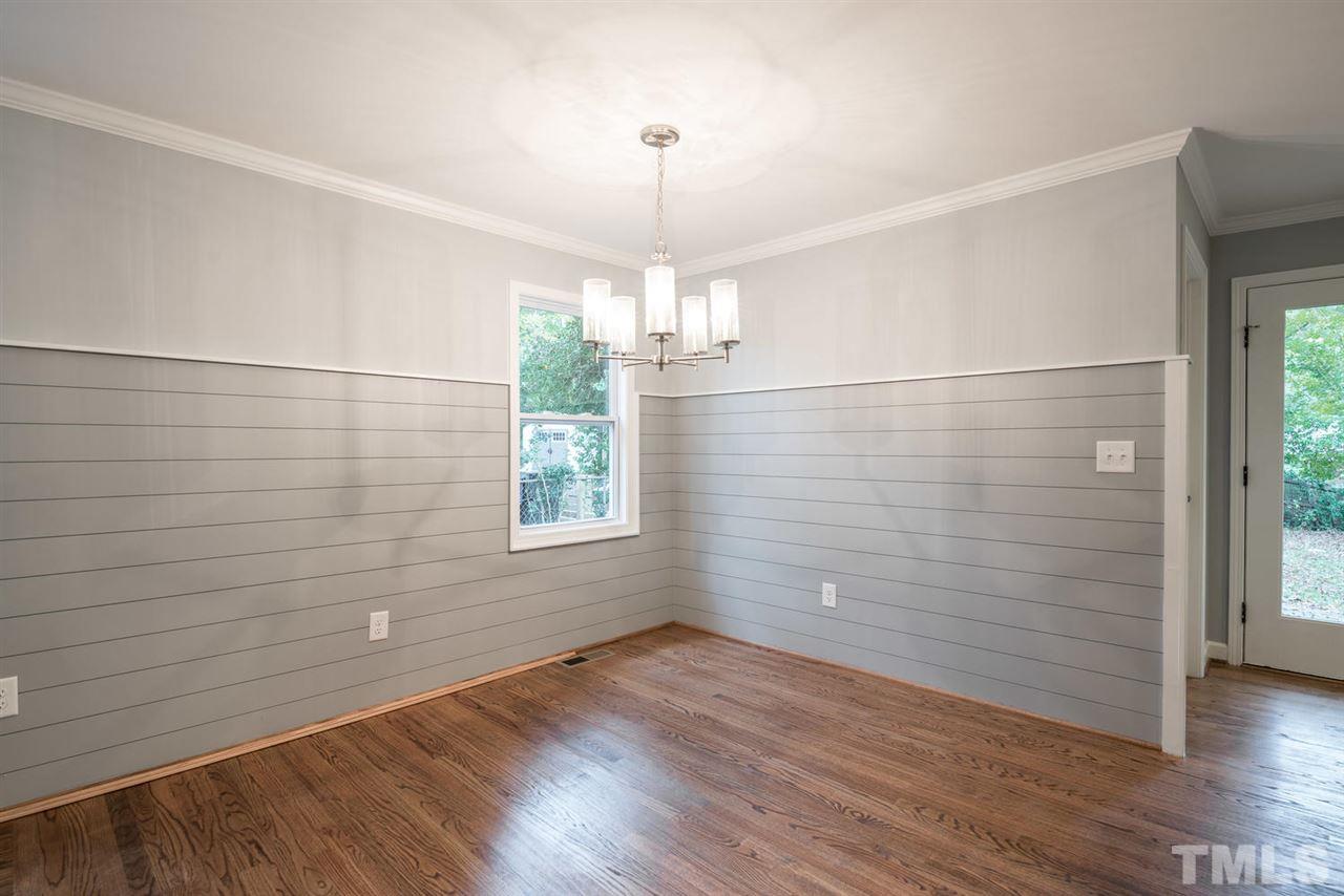 2408 Milburnie Road Raleigh, NC 27610 - Photo 9 of 25 wooden floor in an empty room with a window