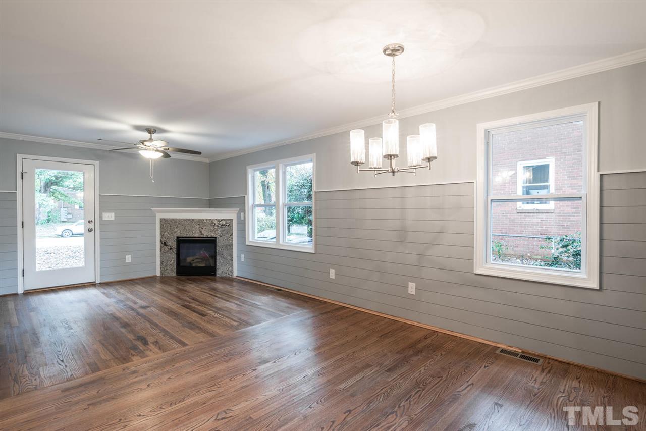 2408 Milburnie Road Raleigh, NC 27610 - Photo 10 of 25 a view of an empty room with wooden floor and a window