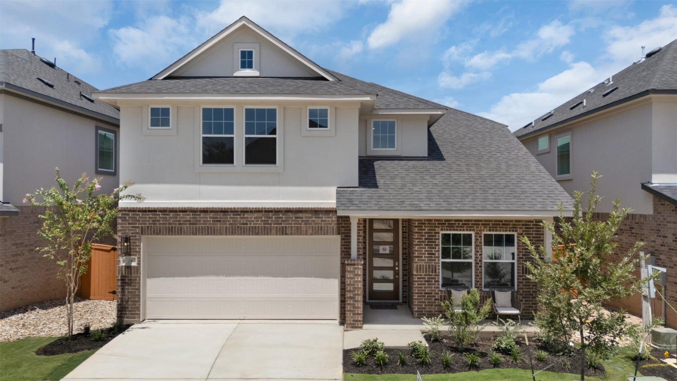 2705 Sage Ranch Drive, Unit 24 Leander, TX 78641 - Photo 1 of 1 View of front of property featuring brick siding, driveway, an attached garage, and stucco siding