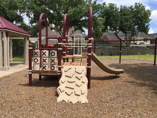 front view of a house with a park bench