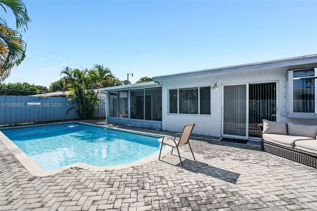 a swimming pool with outdoor seating