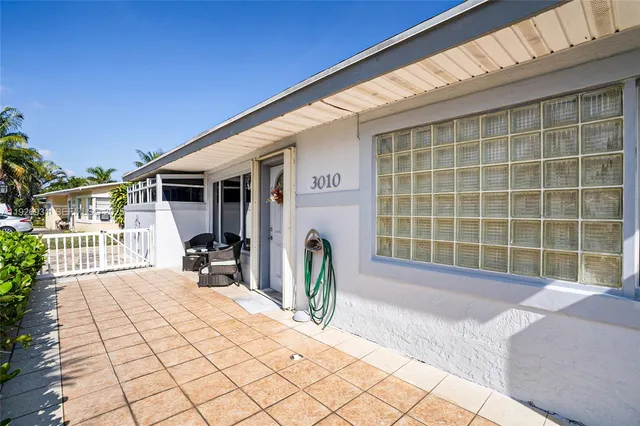 a view of a house with backyard and sitting area