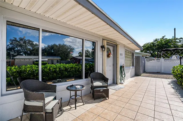a building outdoor space with patio furniture and potted plants