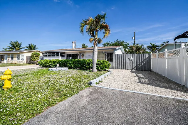 a front view of a house with a yard garage and outdoor seating
