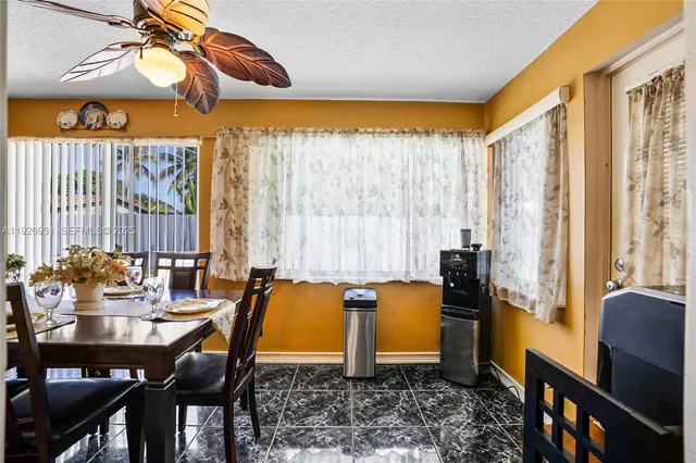 a dining room with furniture and a window