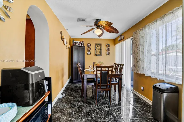 a view of a dining room with furniture and window