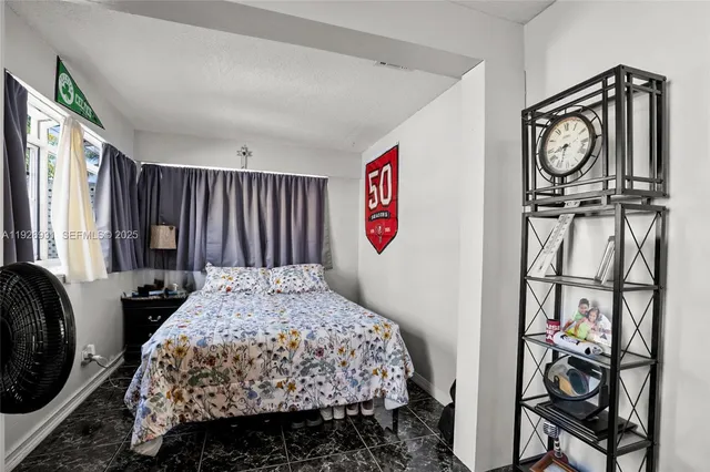 a bedroom with a bed a dresser and a large mirror