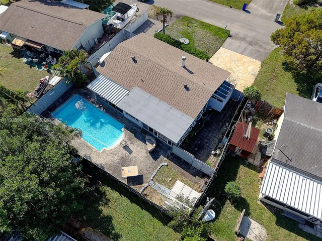 an aerial view of a house with a yard and deck