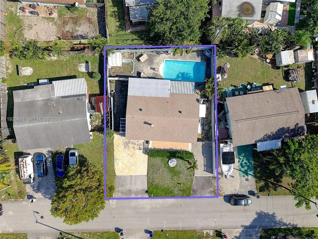 an aerial view of a house with a yard