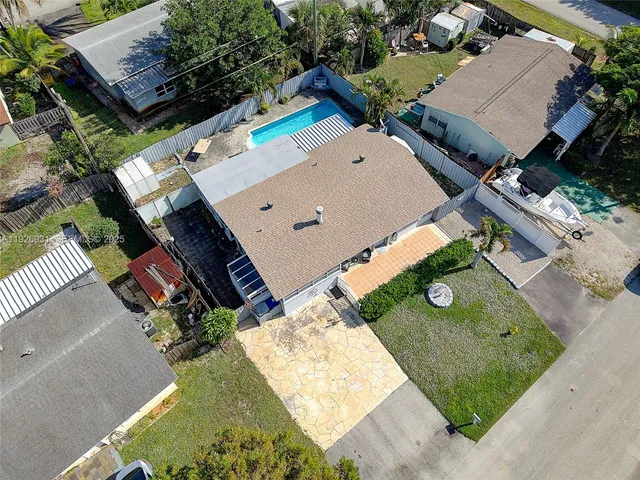 an aerial view of a house with yard