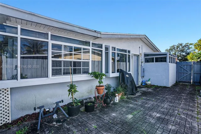 a front view of a house with a yard and seating space