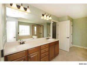 1305 Ridgehaven Road, Unit 165 Waxhaw, NC 28173 - Photo 12 of 16 a bathroom with a sink vanity and a mirror