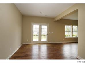 1305 Ridgehaven Road, Unit 165 Waxhaw, NC 28173 - Photo 7 of 16 a view of an empty room with wooden floor and a window