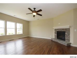 1305 Ridgehaven Road, Unit 165 Waxhaw, NC 28173 - Photo 8 of 16 a view of an empty room with wooden floor and a window