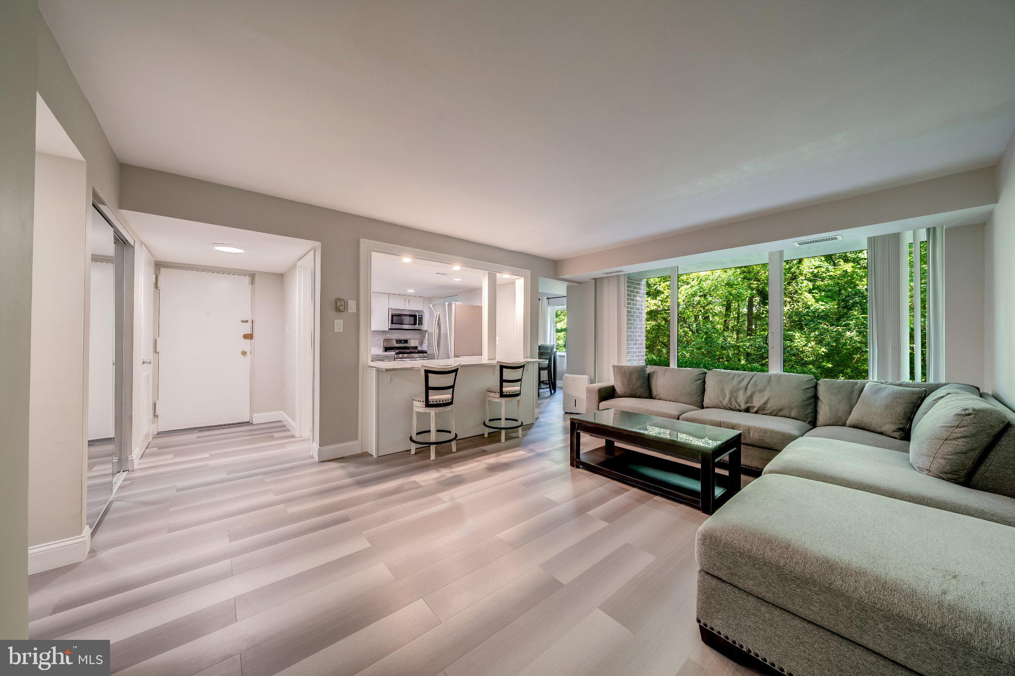 1429 Northgate Square, Unit 2A Reston, VA 20190 - Photo 1 of 25 a living room with furniture and large windows