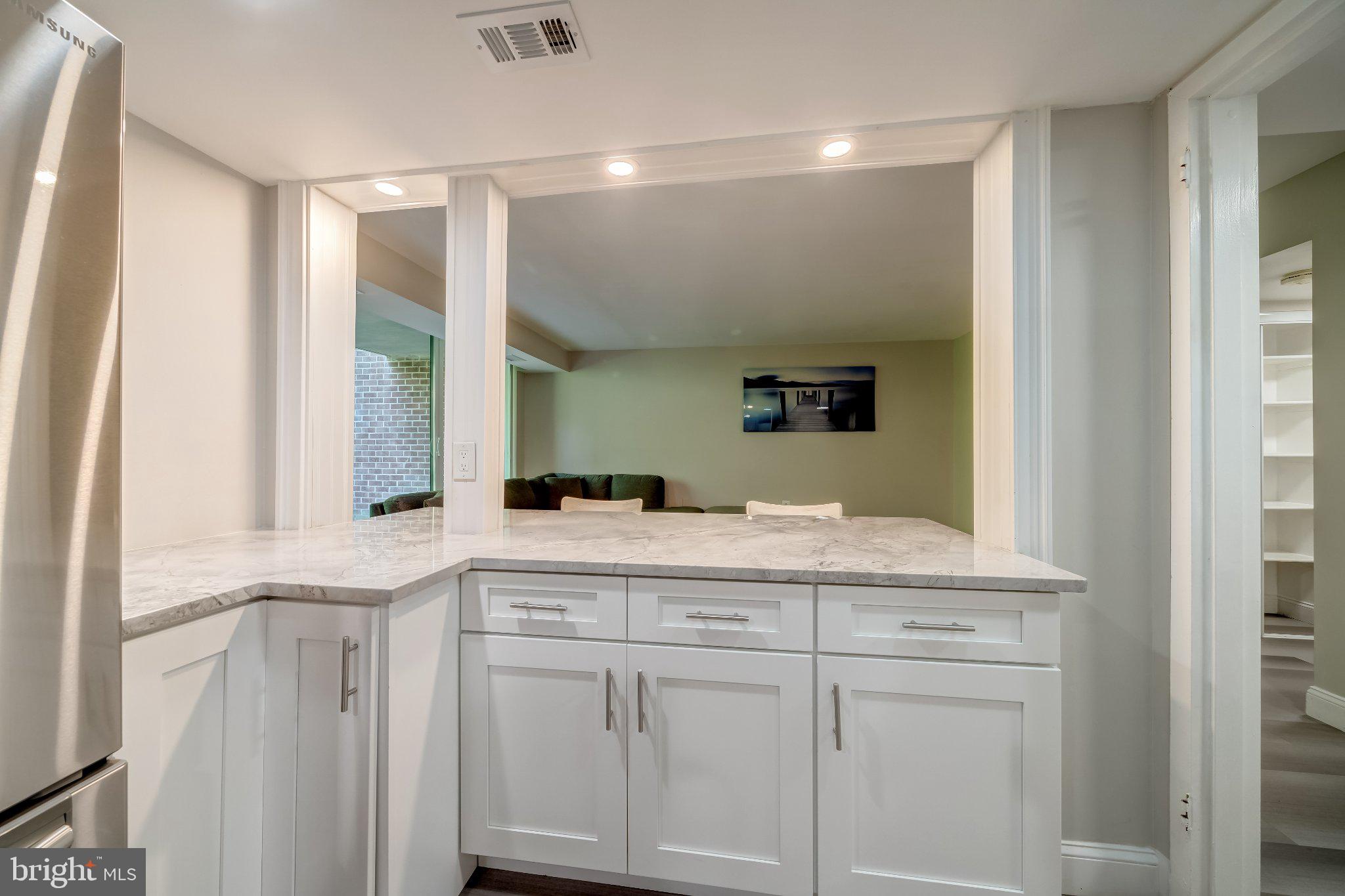 1429 Northgate Square, Unit 2A Reston, VA 20190 - Photo 15 of 25 a bathroom with a granite countertop sink and a mirror