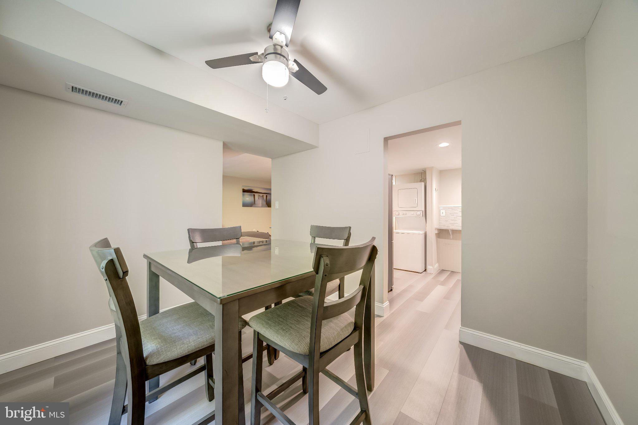 1429 Northgate Square, Unit 2A Reston, VA 20190 - Photo 18 of 25 a view of a dining room with furniture and a chandelier fan