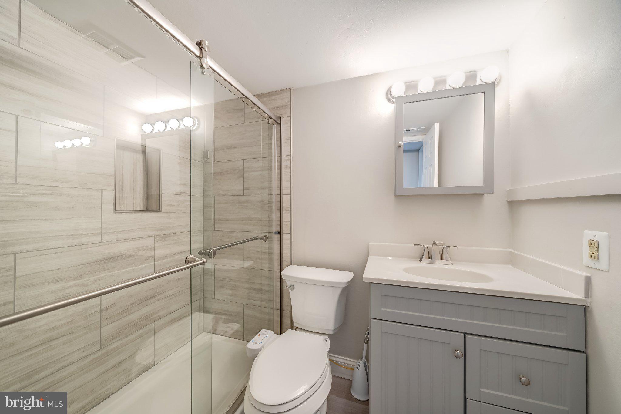 1429 Northgate Square, Unit 2A Reston, VA 20190 - Photo 22 of 25 a bathroom with a sink a toilet and shower