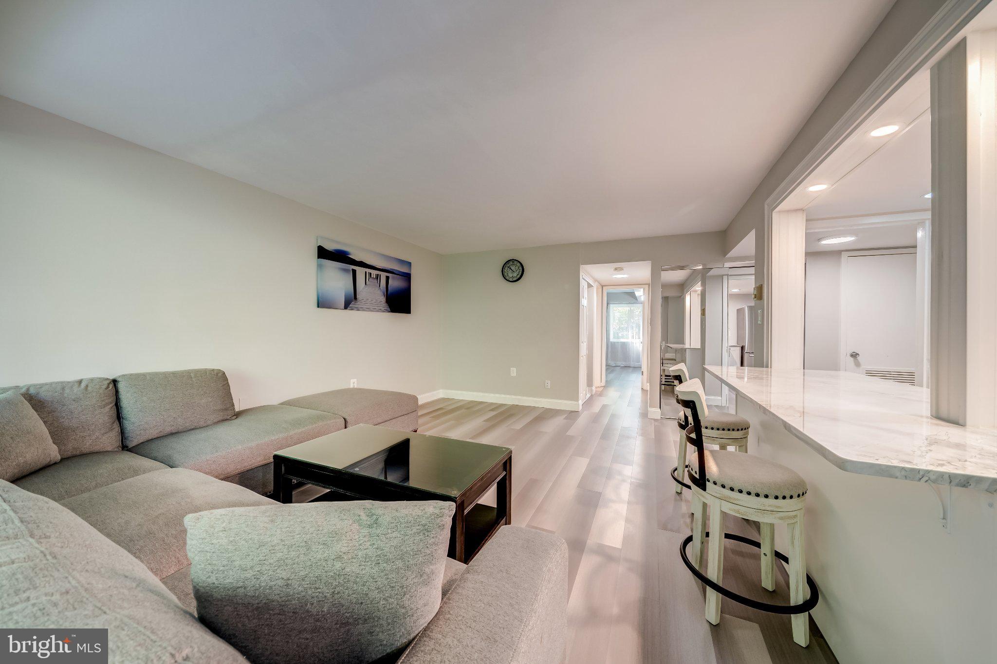 1429 Northgate Square, Unit 2A Reston, VA 20190 - Photo 8 of 25 a living room with furniture rug and a table
