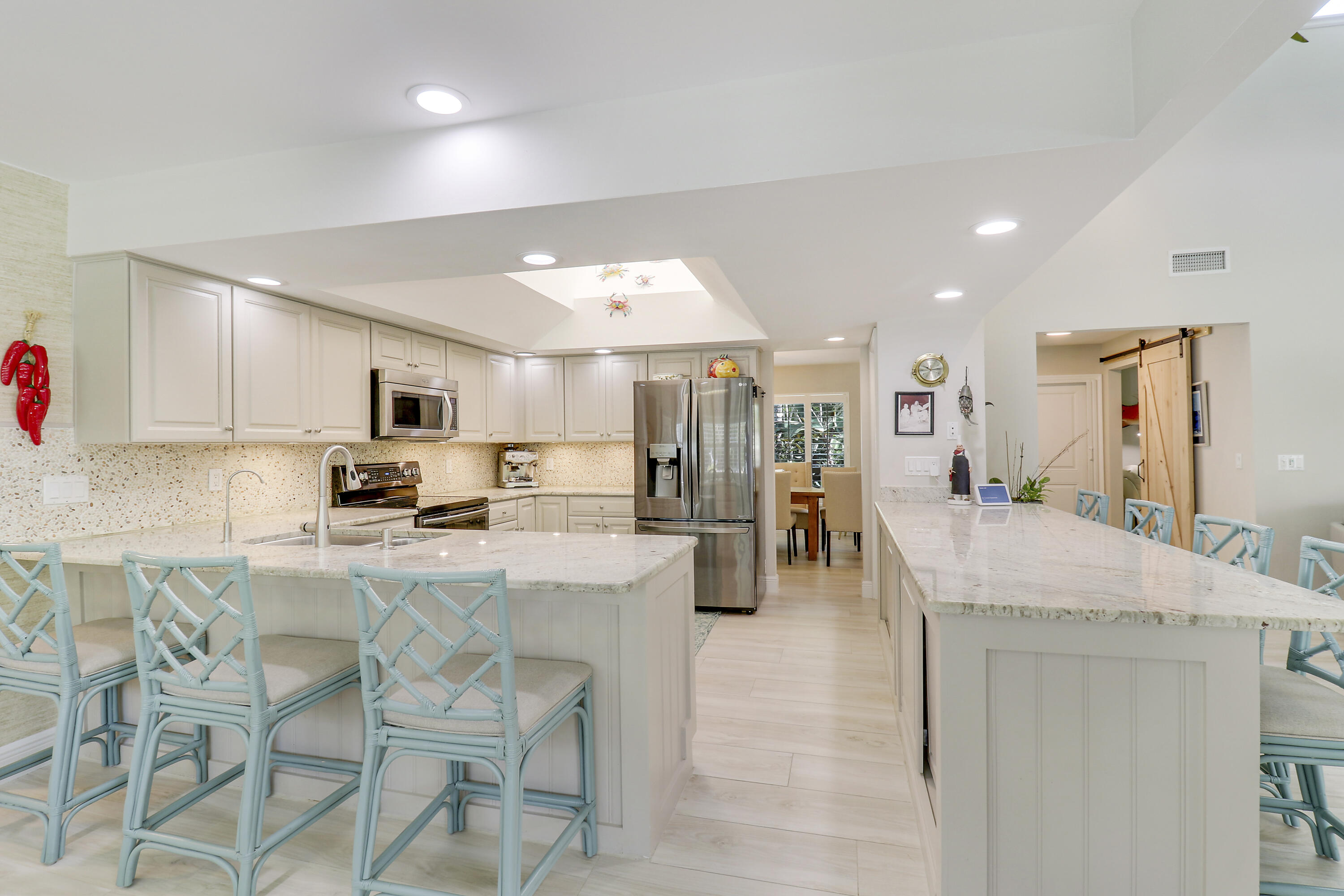 6372 North 197th Place Jupiter, FL 33458 - Photo 13 of 77 a kitchen with stainless steel appliances kitchen island granite top and refrigerator