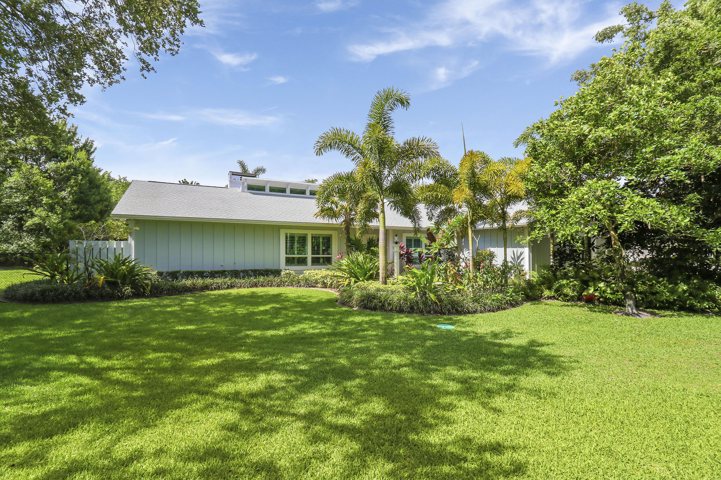 6372 North 197th Place Jupiter, FL 33458 - Photo 2 of 77 a view of a house with a big yard and potted plants and large tree