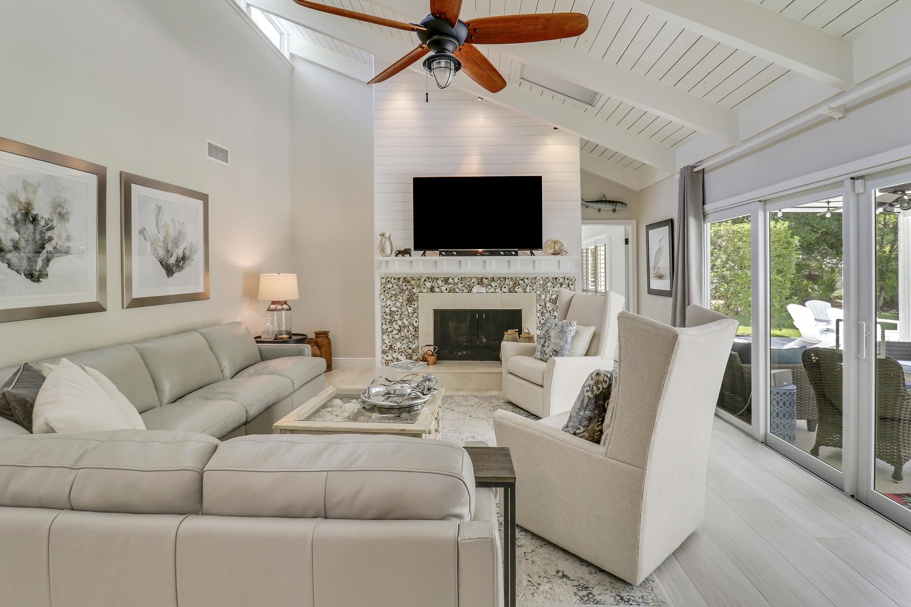 6372 North 197th Place Jupiter, FL 33458 - Photo 23 of 77 a living room with furniture a flat screen tv and a fireplace