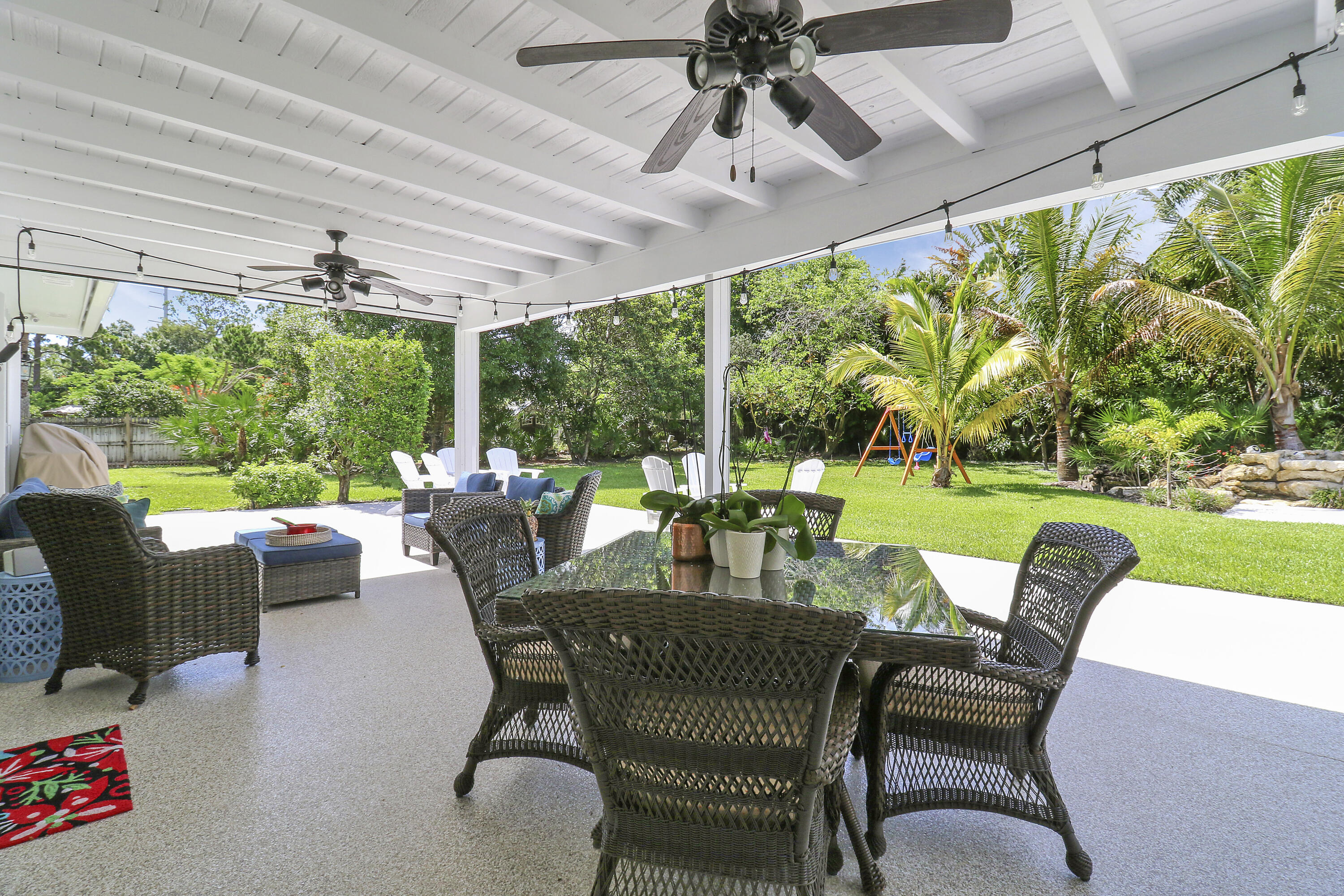 6372 North 197th Place Jupiter, FL 33458 - Photo 31 of 77 a view of a patio with a table chairs and a backyard