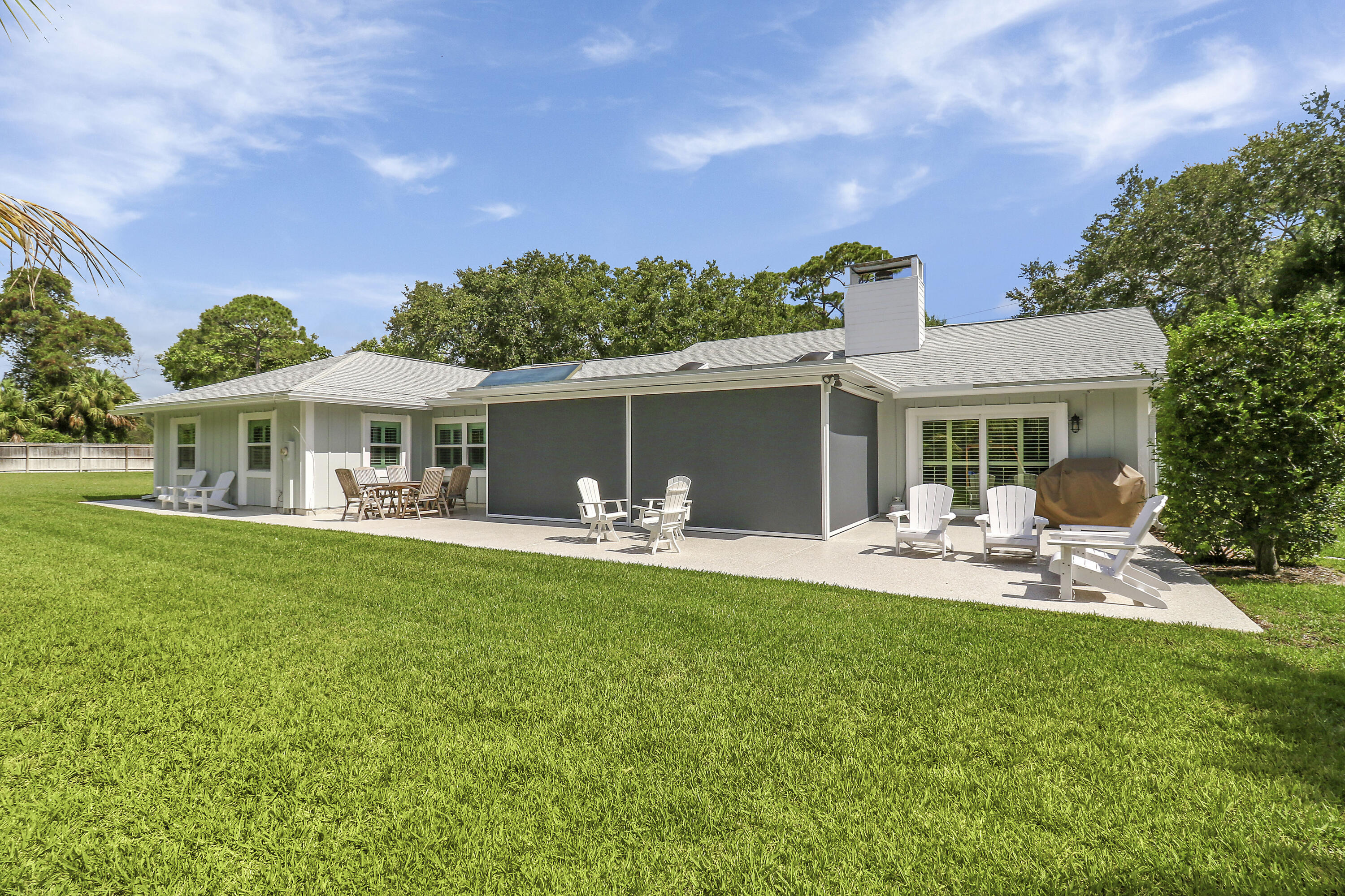 6372 North 197th Place Jupiter, FL 33458 - Photo 35 of 77 a front view of a house with a garden and patio