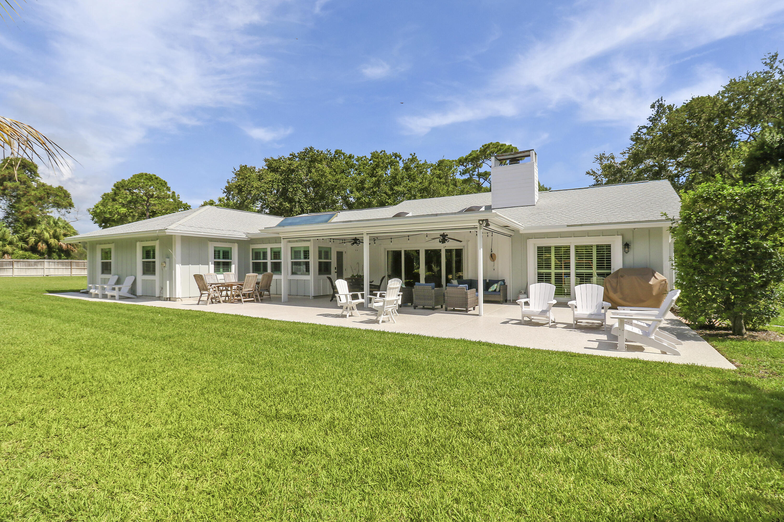 6372 North 197th Place Jupiter, FL 33458 - Photo 36 of 77 a front view of a house with swimming pool having outdoor seating