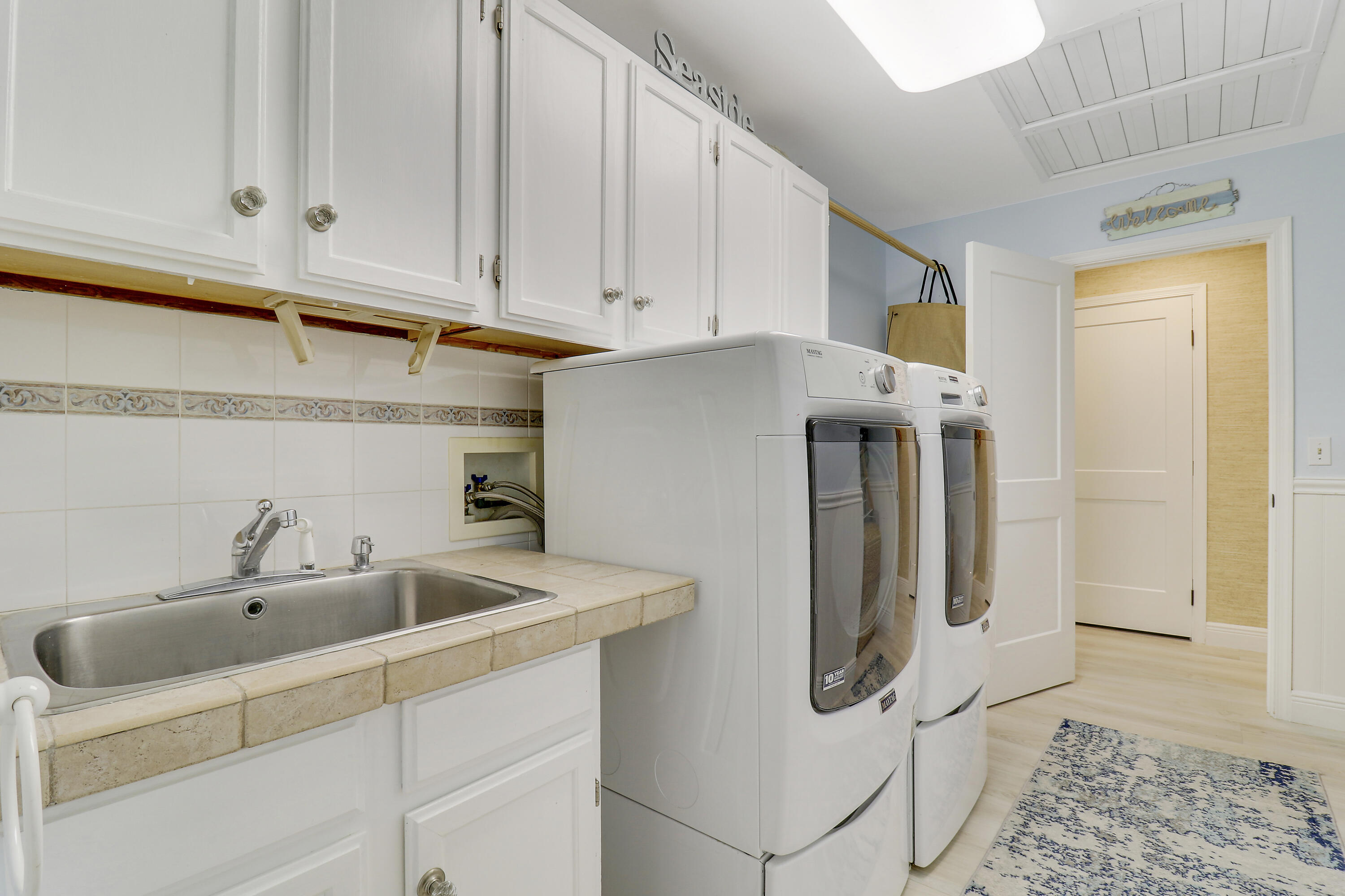6372 North 197th Place Jupiter, FL 33458 - Photo 40 of 77 a kitchen with stainless steel appliances granite countertop a refrigerator and a sink