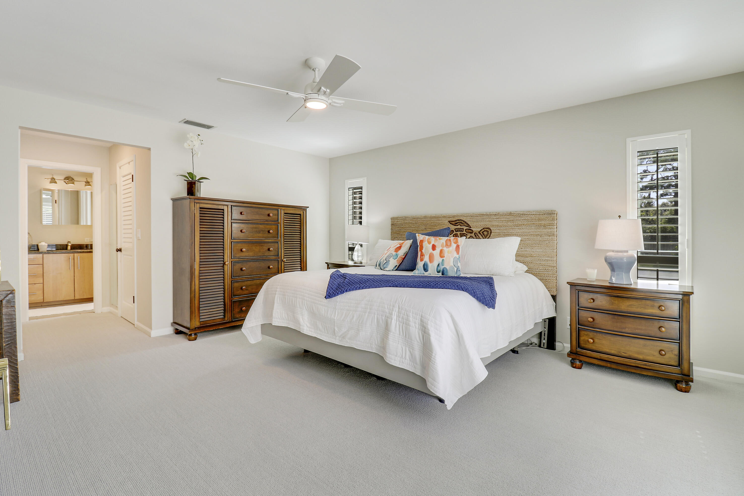 6372 North 197th Place Jupiter, FL 33458 - Photo 47 of 77 a spacious bedroom with a bed and cabinet