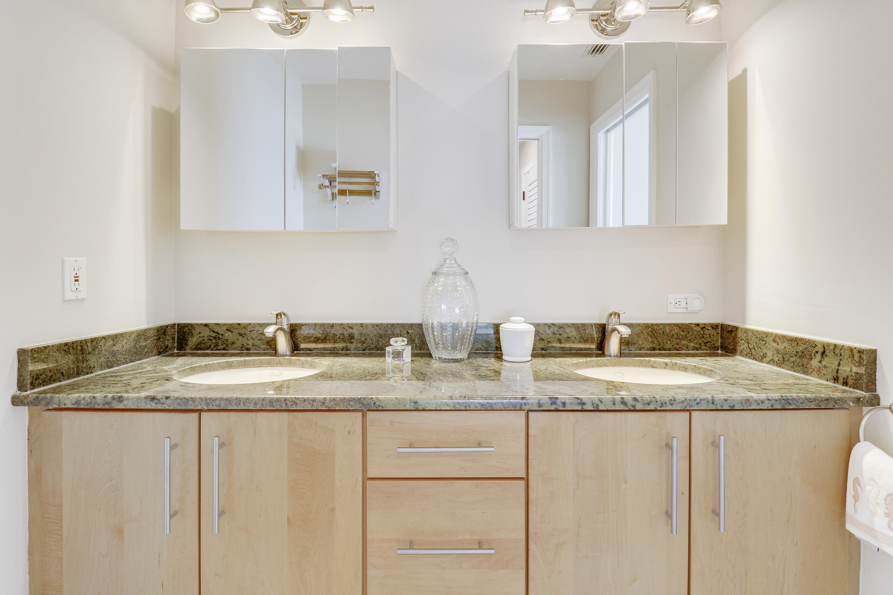 6372 North 197th Place Jupiter, FL 33458 - Photo 49 of 77 a bathroom with a granite countertop sink and a mirror
