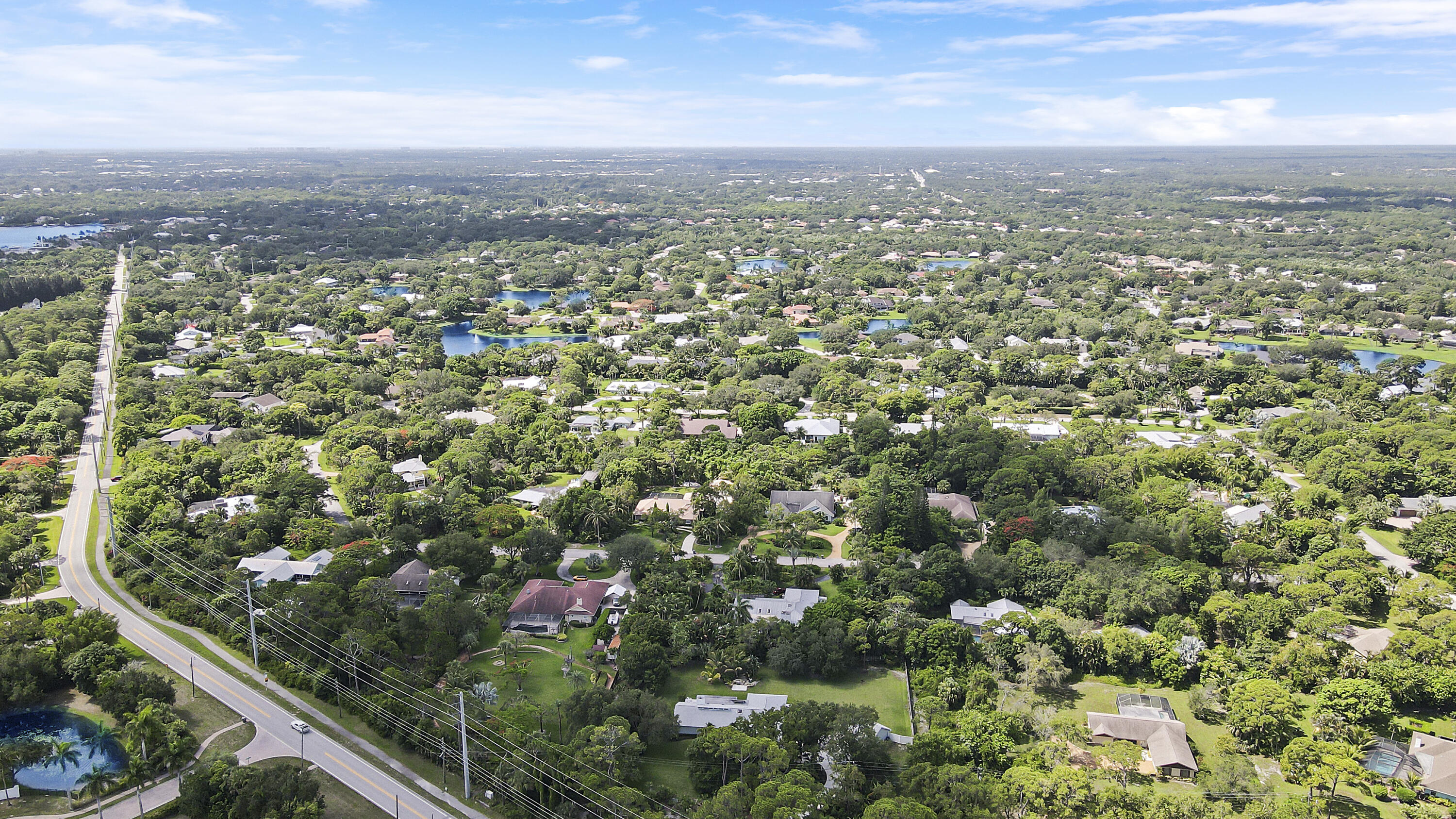 6372 North 197th Place Jupiter, FL 33458 - Photo 54 of 77 an aerial view of residential houses with city view and mountain view in back