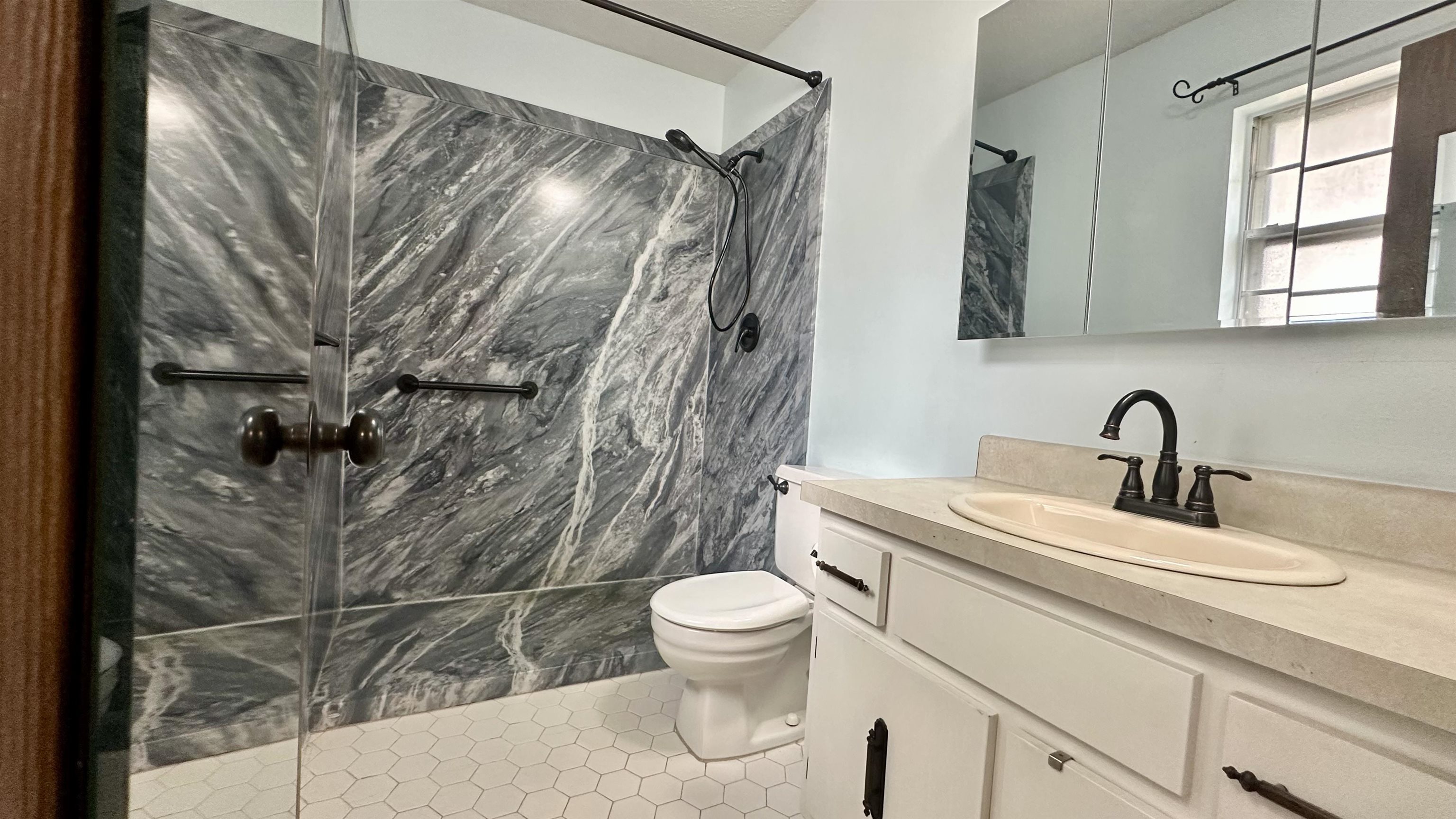 3250 Altruria Road Bartlett, TN 38134 - Photo 14 of 31 a bathroom with a sink a toilet and a mirror