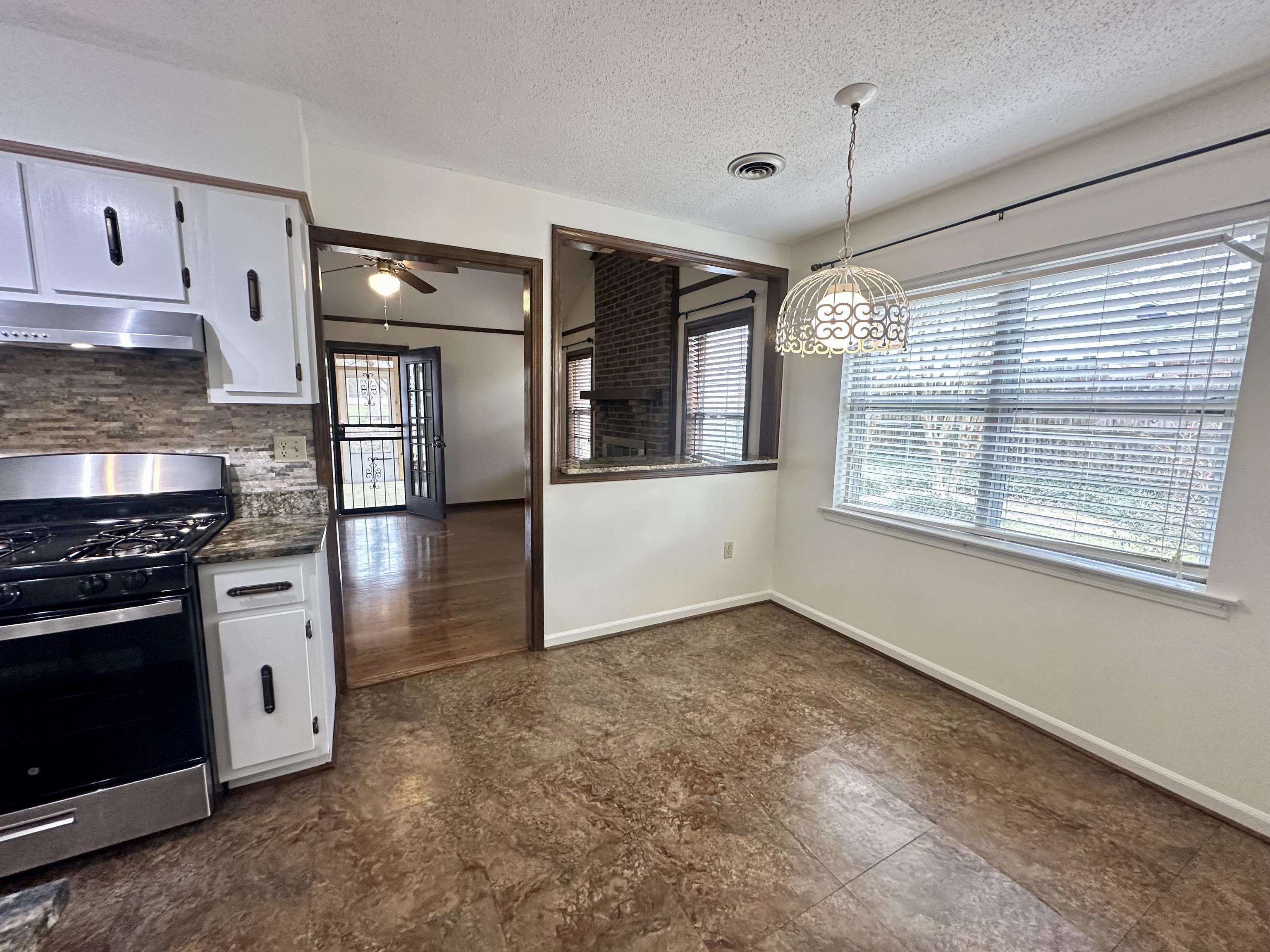 3250 Altruria Road Bartlett, TN 38134 - Photo 21 of 31 a kitchen with stainless steel appliances granite countertop a stove and a refrigerator