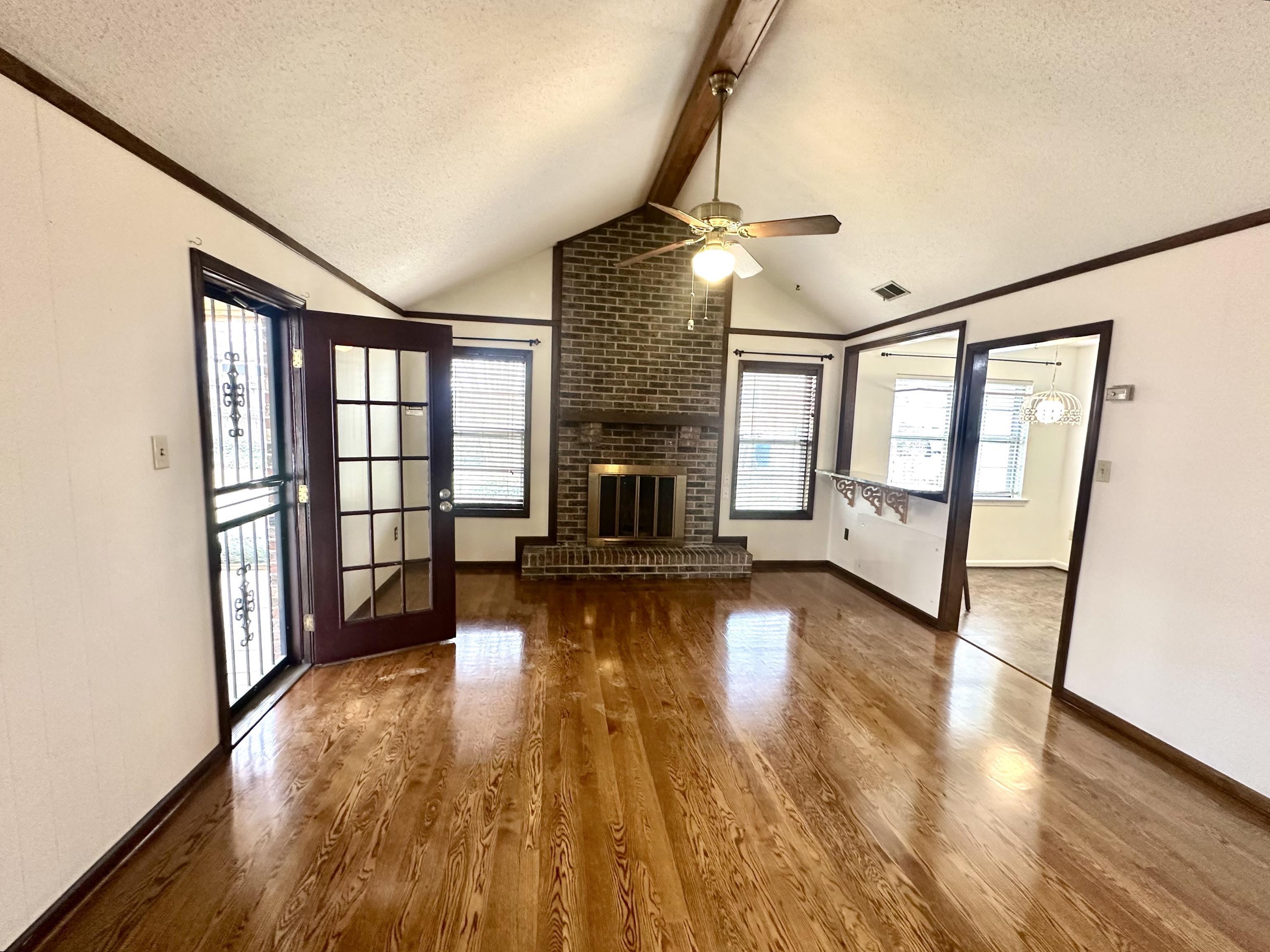 3250 Altruria Road Bartlett, TN 38134 - Photo 7 of 31 a view of empty room with fireplace and wooden floor