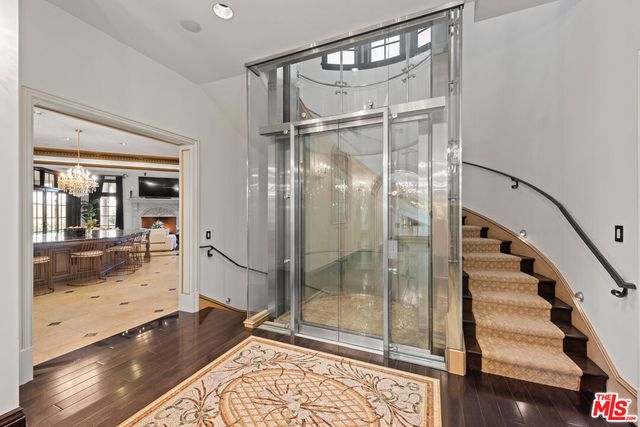 a bathroom with a glass shower door and a glass door