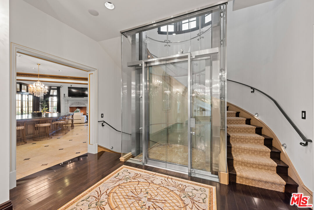 25220 Walker Road Hidden Hills, CA 91302 - Photo 11 of 29 a bathroom with a glass shower door and a glass door