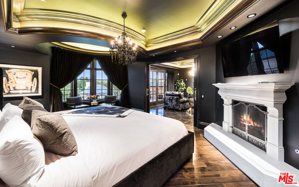 25220 Walker Road Hidden Hills, CA 91302 - Photo 12 of 29 a bed room with a bed and a fireplace