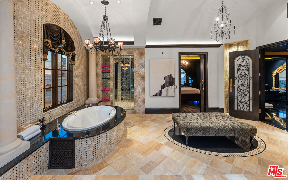 25220 Walker Road Hidden Hills, CA 91302 - Photo 13 of 29 a living room with furniture a chandelier and a rug