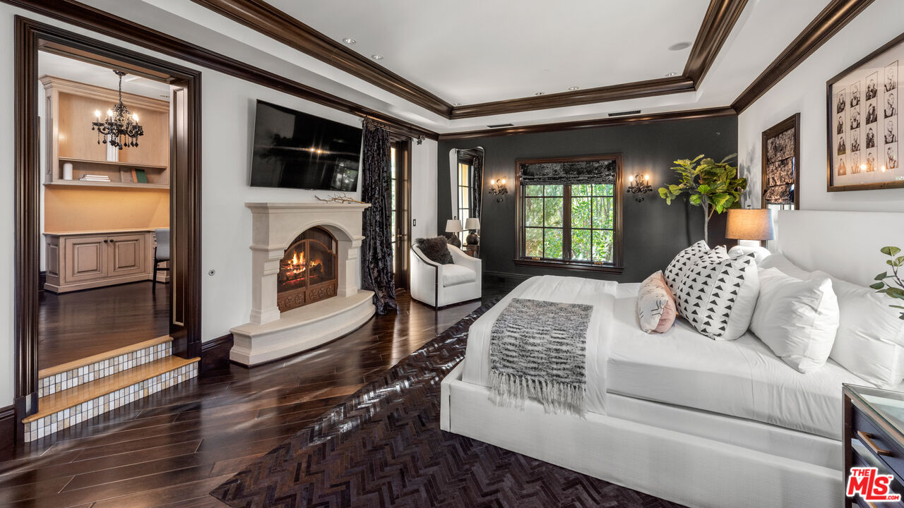25220 Walker Road Hidden Hills, CA 91302 - Photo 15 of 29 a living room with furniture fireplace and flat screen tv