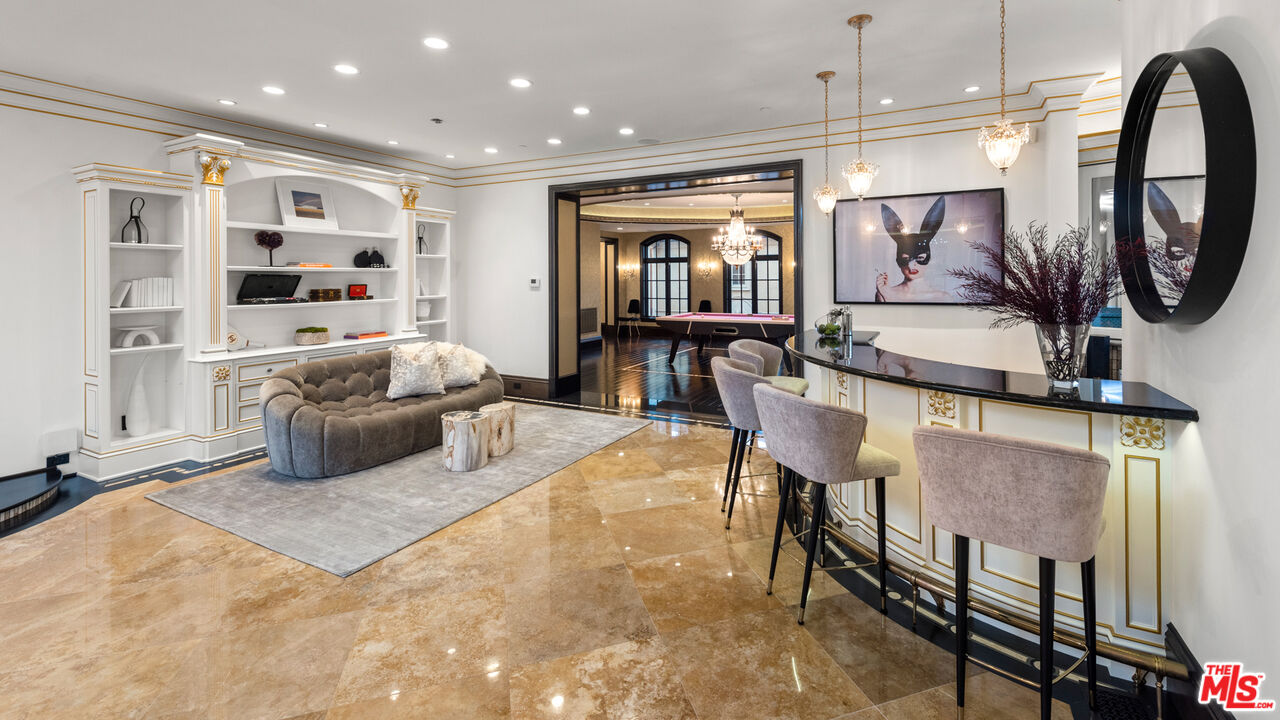 25220 Walker Road Hidden Hills, CA 91302 - Photo 20 of 29 a living room with furniture a mirror and a flat screen tv
