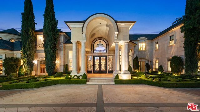 a view of a brick house with a clock tower in front of it