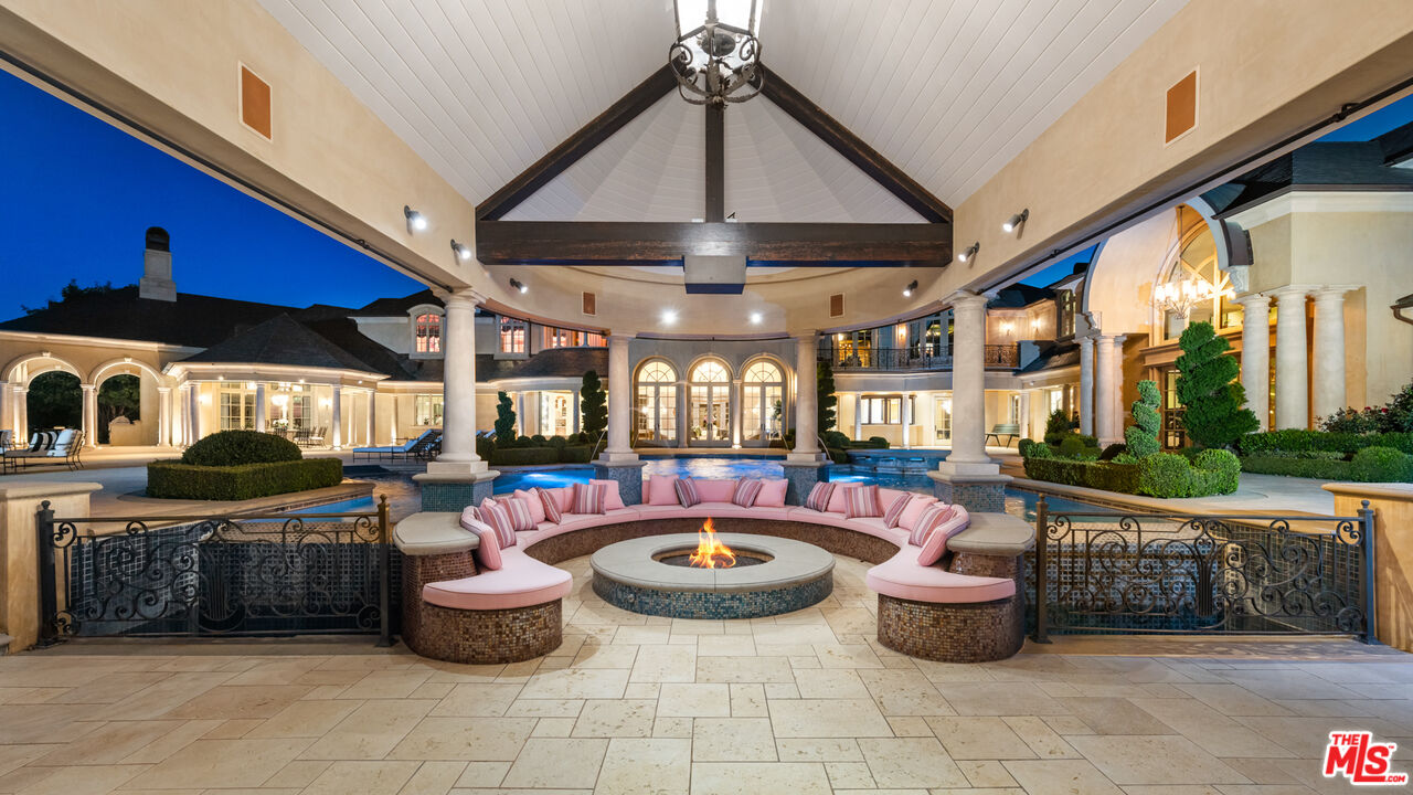 25220 Walker Road Hidden Hills, CA 91302 - Photo 26 of 29 a living room with furniture a fireplace and a large window