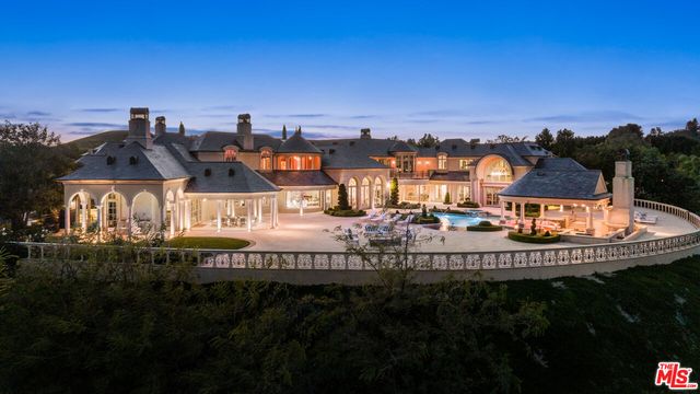 a view of a house with outdoor space and sitting area