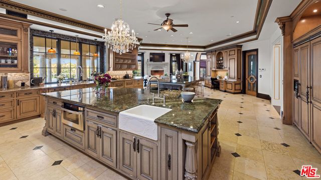 a kitchen with stainless steel appliances granite countertop a sink a stove and a refrigerator
