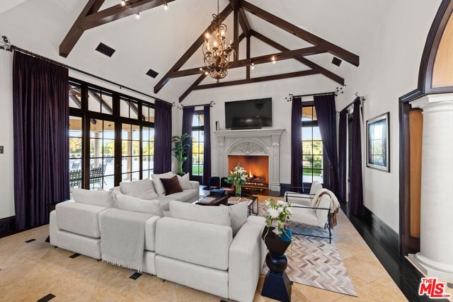 a living room with furniture fireplace and a large window