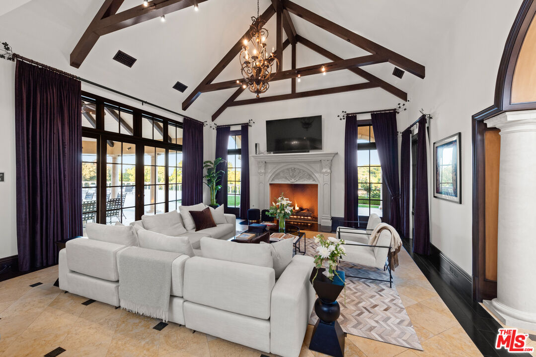25220 Walker Road Hidden Hills, CA 91302 - Photo 9 of 29 a living room with furniture fireplace and a large window